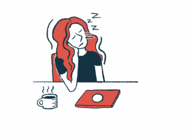 A woman sleeps at a desk with a closed laptop and coffee cup on it.