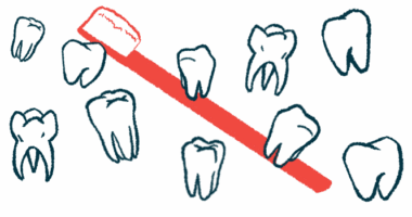 Several teeth of different shapes and sizes are seen floating in front of a red toothbrush.